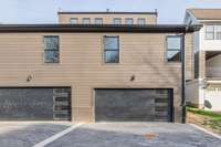 The two-car garage with two additional parking spaces for two cars within the garage itself and two more cars can be parked outside. This setup is perfect for households with multiple vehicles or for accommodating guests.