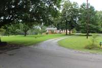 Small driveway entrance into the 2972 Melvin Rd property. Beautiful fields, trees, barn, & more.