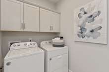 Laundry room conveniently located downstairs near primary suite.