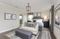 Oversized primary suite downstairs boasting with natural light! King size furnishings shown here.