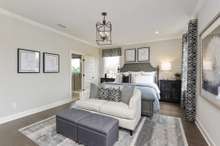 Oversized primary suite downstairs boasting with natural light! King size furnishings shown here.