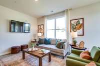 Living room has double windows and glass patio door for lots of natural light!