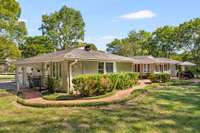 Attached 2 vehicle garage and brick pathway leading to back patio.  Fully fenced backyard