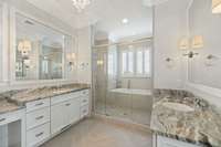 Spa like Primary bath with double vanities, framed mirrors and wet room