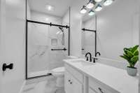 Bedroom 3 - private bathroom with stunning tile, quartz countertops and black accents