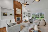 beautiful built-ins on each side of the brick wood burning fireplace, double fans, lovely picture windows