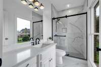 Bedroom 2 spectacular private bathroom with quartz countertops and luxury tile