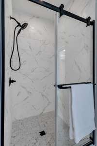 Ensuite walk-in shower with stunning tile and black accents