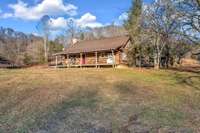 The AS IS original cabin on the property is livable and charming.