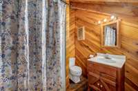 Upstairs bath features a shower stall and single vanity.