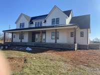 coming along!  Concrete drive when it quits raining... Beautiful red oak beams!