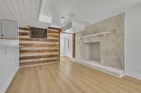 Basement living area with wood burning fireplace.