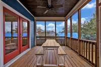 Enjoy dining or gathering outside on this screened in porch, with a fan!