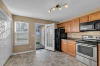 Kitchen opens to the private patio/backyard with outdoor storage