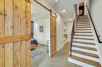 Entering the home from the front door, polished concrete floors on this level.  Sliders reveal bedroom #1