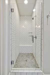 Primary bath separate shower. Tile and glass