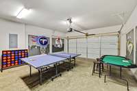2-Car garage being utilized as a game room. Guests can play Table Tennis, Cornhole, Connect 4, Darts, Card Games, Five Dice, and more!