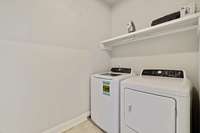 The laundry room is upstairs with the bedrooms. Full size washer/dryer pair and additional storage