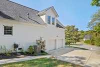 2 car garage with tall ceilings and lots of metal cabinets and shelving for the handyman.  New HVAC system.