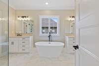 Stand alone soaking tub completes this stunning primary bathroom