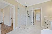 Primary bathroom featuring a gorgeous tile shower with glass doors