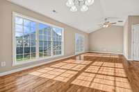 Living Room and Dining Room with Vaulted Ceilings, Large Windows, Beautiful Floors and Fresh Painted Walls