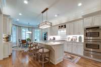 Gourmet  kitchen with hardwood floors, Breakfast area. Lots of custom cabinetry, large center island.