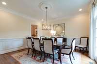 Formal dining room with hardwood floors, and custom trim work.