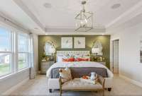 Oversized primary bedroom with trey ceiling & great natural light!