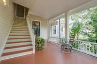 Rear wrap around covered porch with original exterior stairway to the upper level.