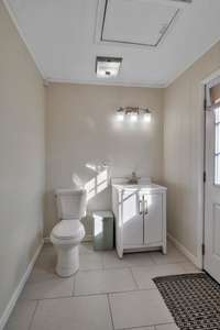 View of the half bath combined with the laundry room.