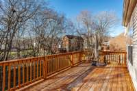 Large deck located just off the kitchen w/ lots of mature treees located on the property creating  privacy and a 6 ft privacy fence!