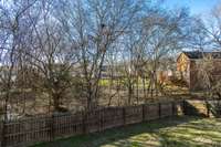 The rear property line extends well beyond the back of the fence line and has lots of Trees creating tons of privacy!