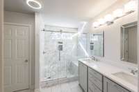 Custom Remodeled Owner's bathroom w/ large tiled walk-in shower w/ bench seat and custom vanity w/ quartz top!!!