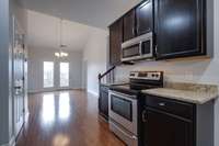 Kitchen (Stove + Microwave) + Dining room in back