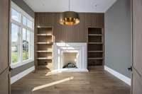 Private Study with ventless fireplace includes fire balls, custom built oak adjustable shelves and 10' stained wood doors.  This home is virtually staged. Built by: Schumacher Homes, LLC