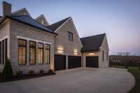 4-car garage includes a stupendous exercise room.  Spacious driveway and garage exterior lights.  Built by: Schumacher Homes, LLC