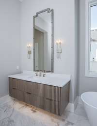 Elegant double vanities with under vanitiy lighting and designer finishes.  *this home is virtually staged.  Built by: Schumacher Homes, LLC