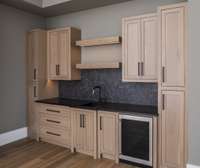 Entertainer's wet bar with custom oak cabinetry.   Built by: Schumacher Homes, LLC