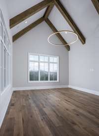 Main level Media room with vaulted ceiling.  *This home is virtually staged.   Built by: Schumacher Homes, LLC