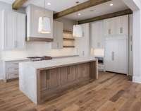 Open Chef Kitchen with state-of-the-art-appliances, custom cabinetry, waterfall island and window over apron front sink.  *this home is virtually stage. Built by: Schumacher Homes, LLC