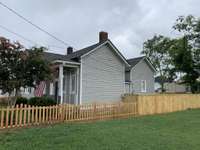 Side view of home.  New picket and privacy fence.