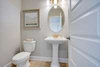 Powder room downstairs near dining/study for guests.