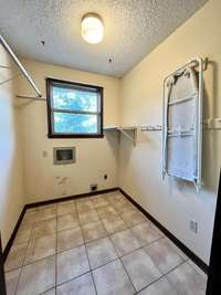 Conveniently situated off the kitchen, the home features a laundry room with a durable tile floor.