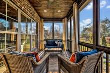 The lovely back porch features Iron railings and brick steps