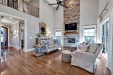 Striking floor to ceiling stacked stone (gas logs) fireplace with a cedar mantle