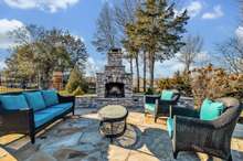 Flagstone and Pigeon River Rock Patio areas, seat wall & custom stacked stone wood burning fireplace!