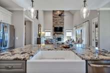 Granite counters and island with beautiful apron farm sink