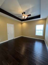 Master Bedroom with Tray Ceiling and Ceiling Fan