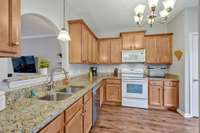 There is ample granite counter space and beautiful warm cabinets for storage